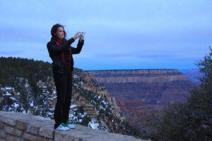 A female taking a photograph of the Grand Canyon