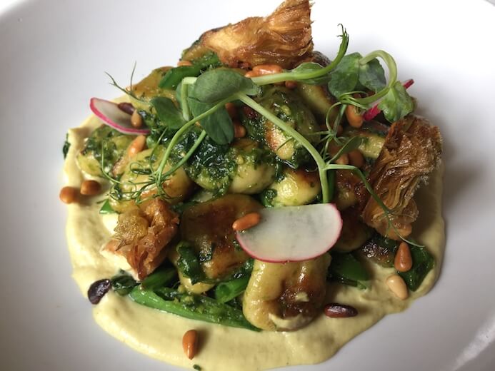 A stunning plate of smoked potato gnocci, wild garlic pesto, violet artichoke, Spring peas and toasted pine nuts from Fallon & Byrne in Dublin