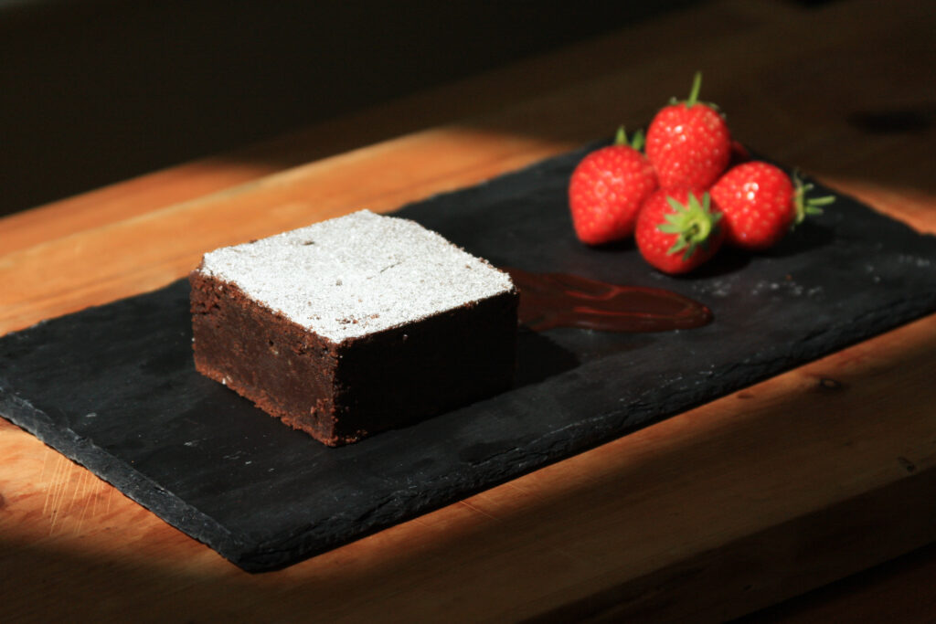 Dark cake with strawberries- food photography and styling by Melanie May