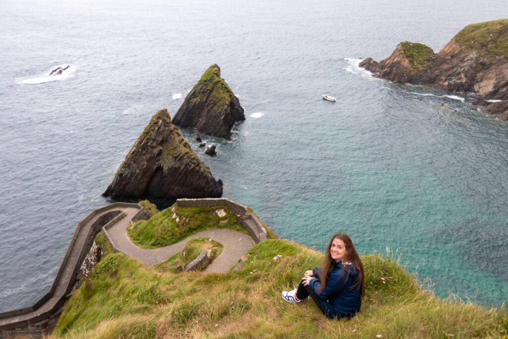 Melanie May Content Creator on a cliff by the sea in Ireland