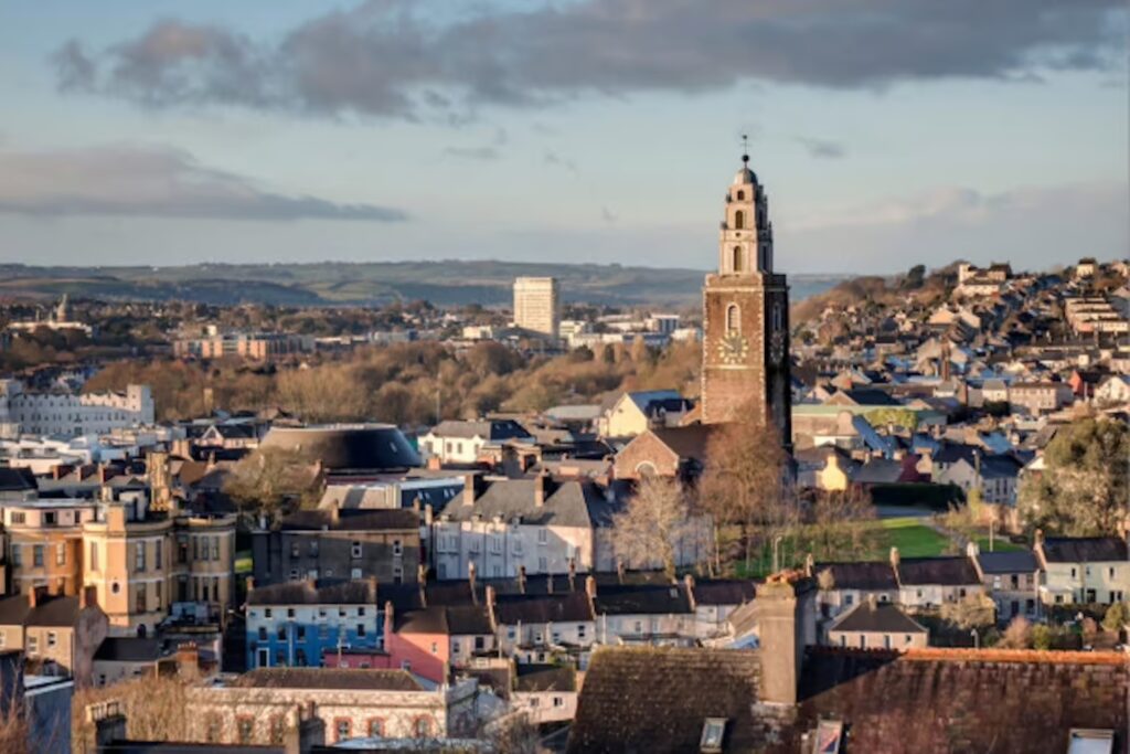 Cork, Ireland. Aerial view of St. Anne`s Church in Shandon, Cork, Ireland. Mountains and cloudy blue sky